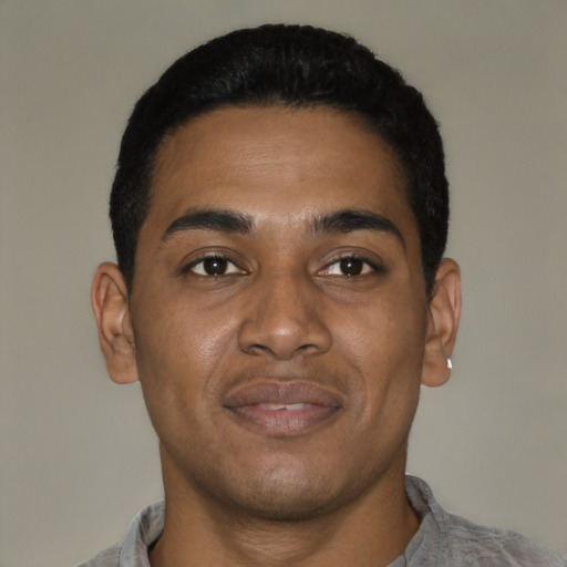 Joyful latino young-adult male with short  black hair and brown eyes