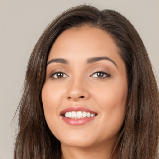 Joyful white young-adult female with long  brown hair and brown eyes