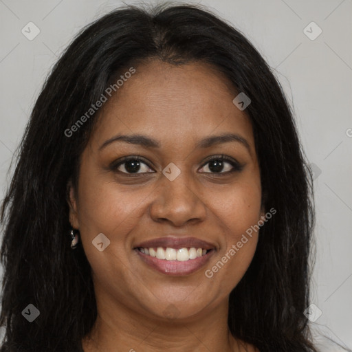 Joyful black young-adult female with long  brown hair and brown eyes