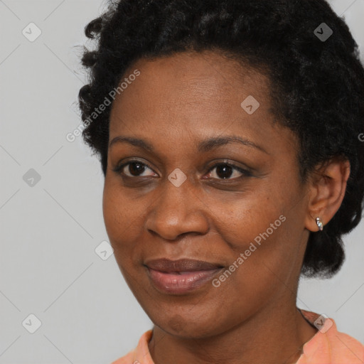 Joyful black adult female with short  brown hair and brown eyes