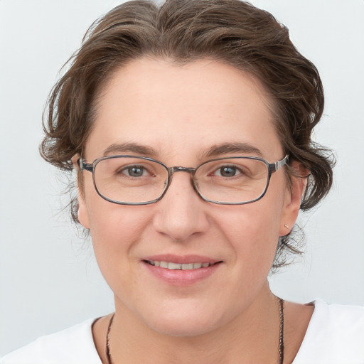 Joyful white adult female with medium  brown hair and blue eyes