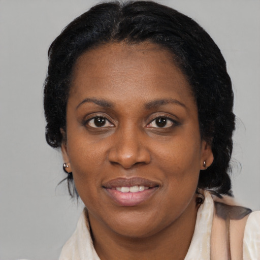 Joyful black adult female with medium  black hair and brown eyes