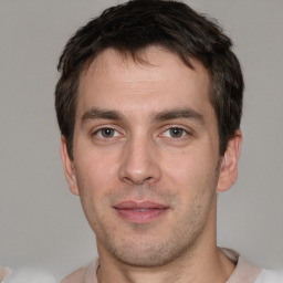 Joyful white adult male with short  brown hair and brown eyes