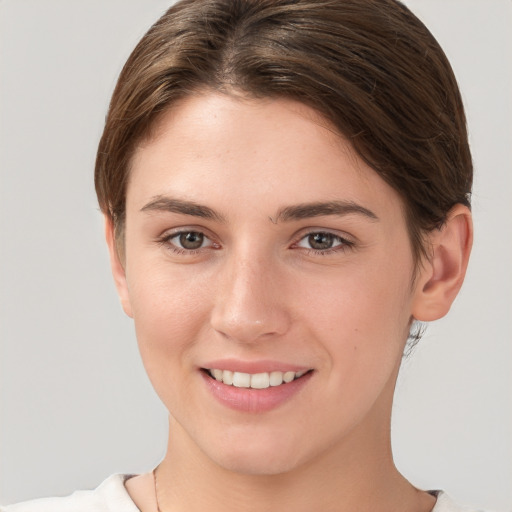 Joyful white young-adult female with short  brown hair and brown eyes