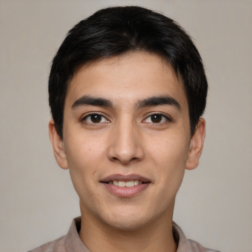 Joyful white young-adult male with short  black hair and brown eyes