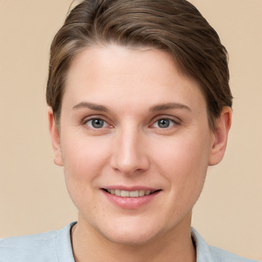 Joyful white young-adult female with short  brown hair and grey eyes