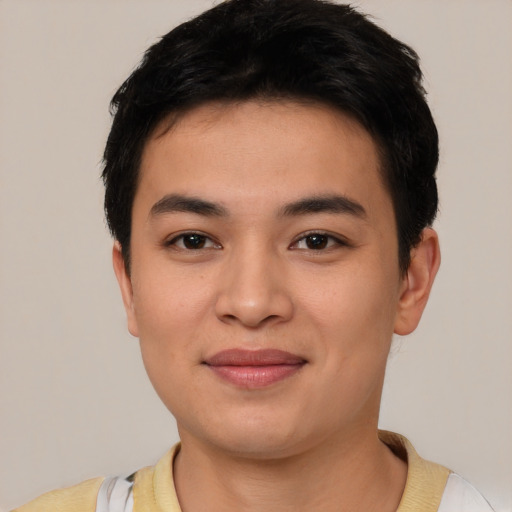 Joyful asian young-adult male with short  black hair and brown eyes