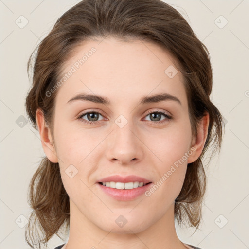 Joyful white young-adult female with medium  brown hair and grey eyes