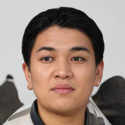 Joyful asian young-adult male with short  black hair and brown eyes