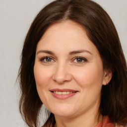 Joyful white adult female with medium  brown hair and brown eyes