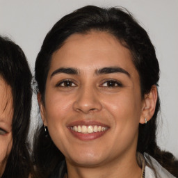 Joyful white young-adult female with medium  black hair and brown eyes