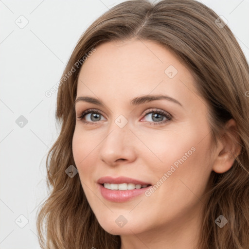 Joyful white young-adult female with long  brown hair and blue eyes