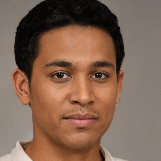 Joyful latino young-adult male with short  brown hair and brown eyes