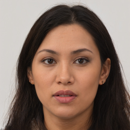 Joyful asian young-adult female with long  brown hair and brown eyes
