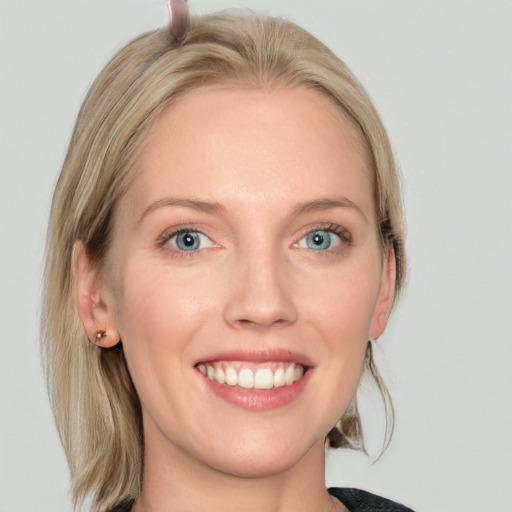 Joyful white young-adult female with medium  brown hair and blue eyes