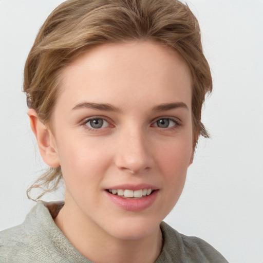 Joyful white young-adult female with short  brown hair and blue eyes