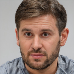 Joyful white adult male with short  brown hair and brown eyes