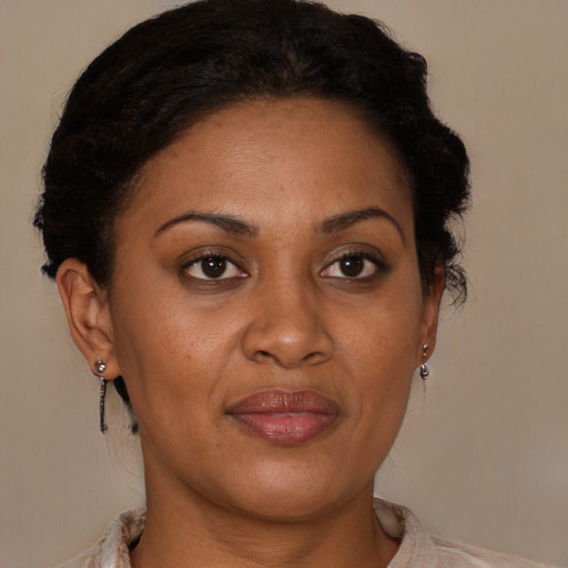 Joyful black adult female with short  brown hair and brown eyes