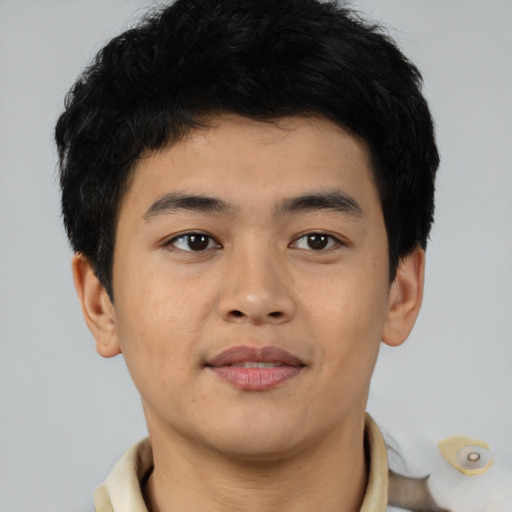 Joyful asian young-adult male with short  black hair and brown eyes
