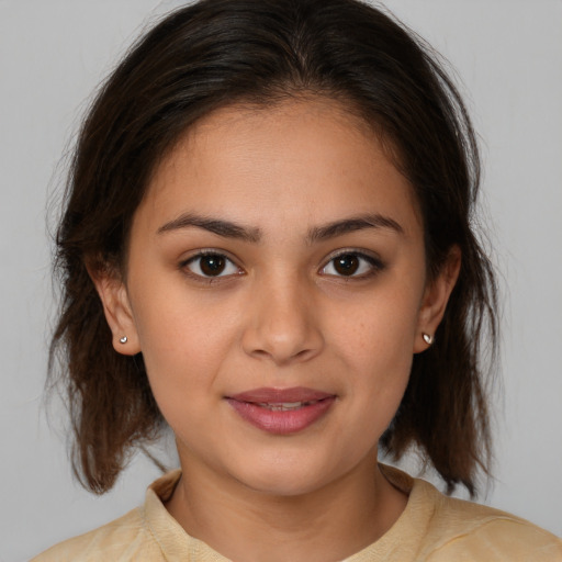 Joyful white young-adult female with medium  brown hair and brown eyes