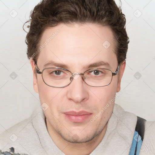 Joyful white adult male with short  brown hair and blue eyes