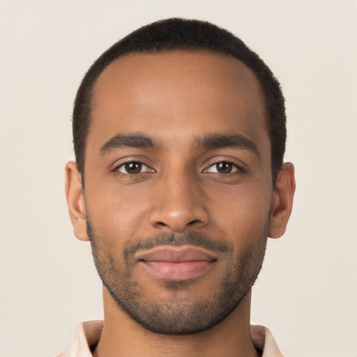 Joyful latino young-adult male with short  brown hair and brown eyes