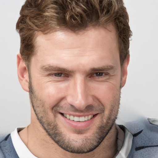 Joyful white adult male with short  brown hair and brown eyes