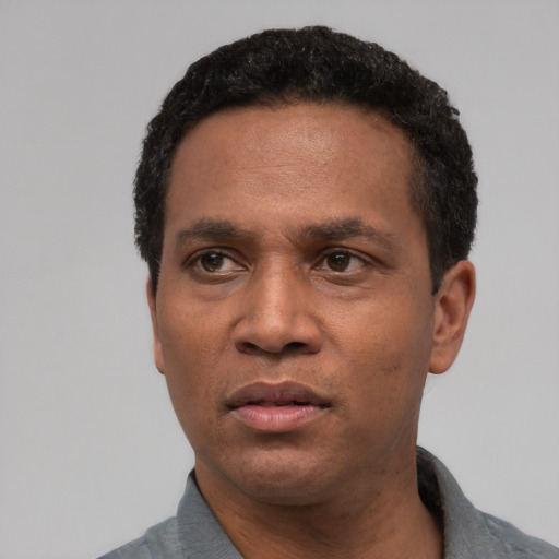 Neutral latino adult male with short  black hair and brown eyes