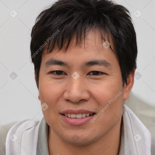 Joyful asian young-adult male with short  brown hair and brown eyes