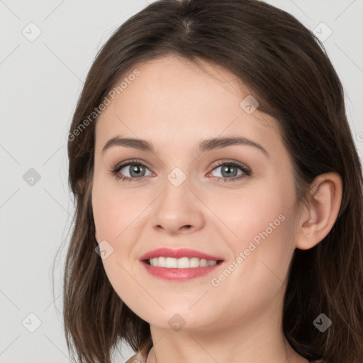 Joyful white young-adult female with long  brown hair and grey eyes