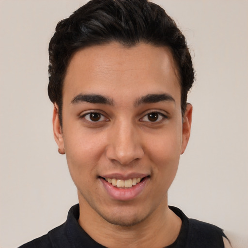 Joyful white young-adult male with short  black hair and brown eyes