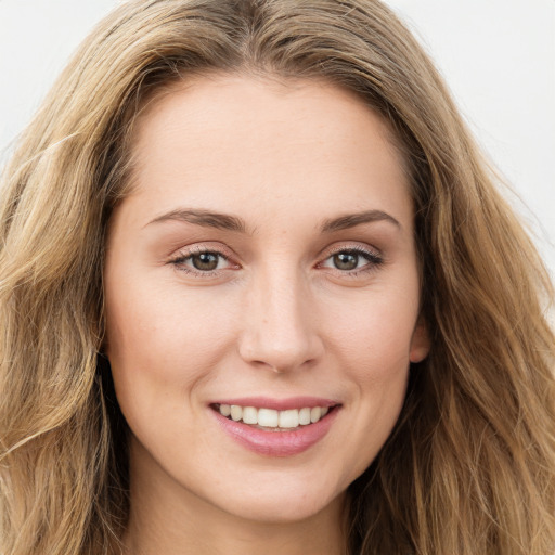 Joyful white young-adult female with long  brown hair and green eyes