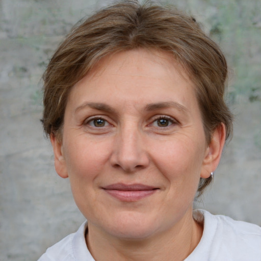 Joyful white adult female with short  brown hair and brown eyes