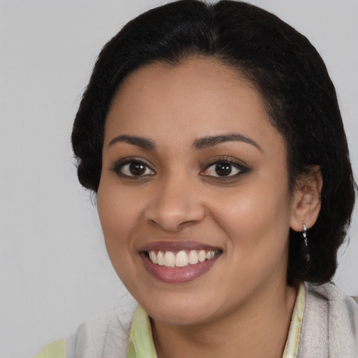 Joyful latino young-adult female with medium  black hair and brown eyes