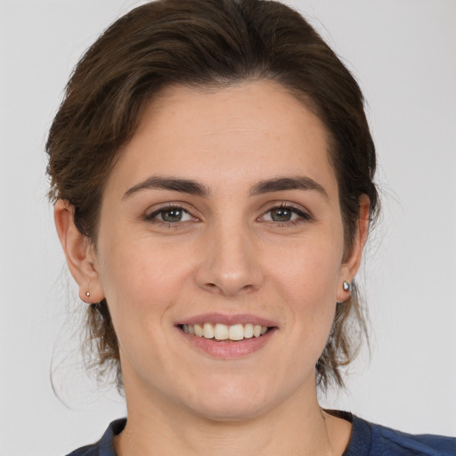 Joyful white young-adult female with medium  brown hair and brown eyes