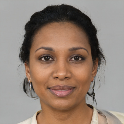 Joyful black young-adult female with medium  brown hair and brown eyes