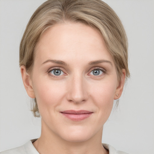 Joyful white young-adult female with medium  brown hair and blue eyes