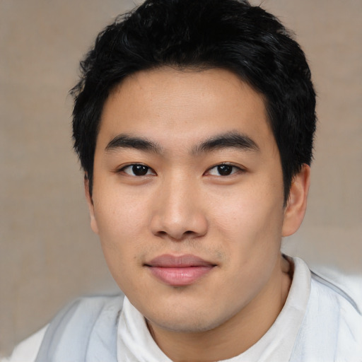 Joyful asian young-adult male with short  black hair and brown eyes