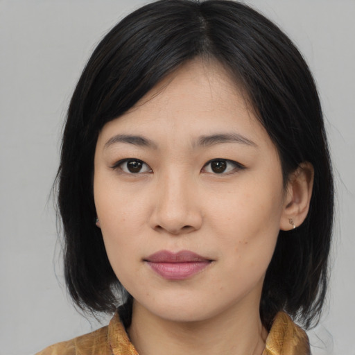 Joyful asian young-adult female with medium  black hair and brown eyes
