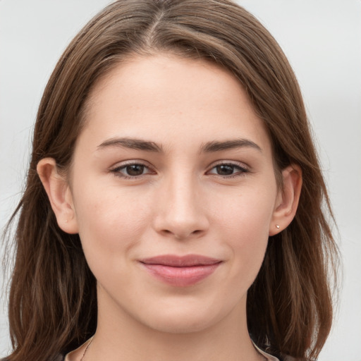 Joyful white young-adult female with long  brown hair and grey eyes