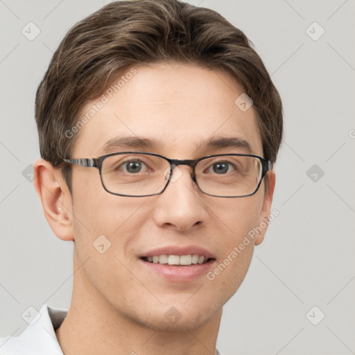 Joyful white young-adult male with short  brown hair and grey eyes