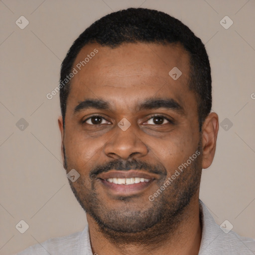 Joyful black young-adult male with short  black hair and brown eyes