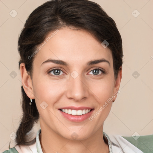 Joyful white young-adult female with medium  brown hair and grey eyes