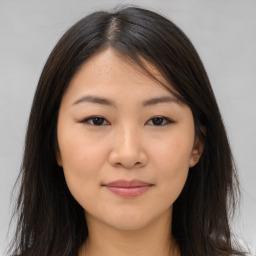 Joyful asian young-adult female with long  brown hair and brown eyes