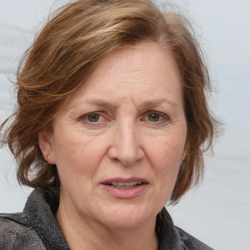 Joyful white adult female with medium  brown hair and blue eyes