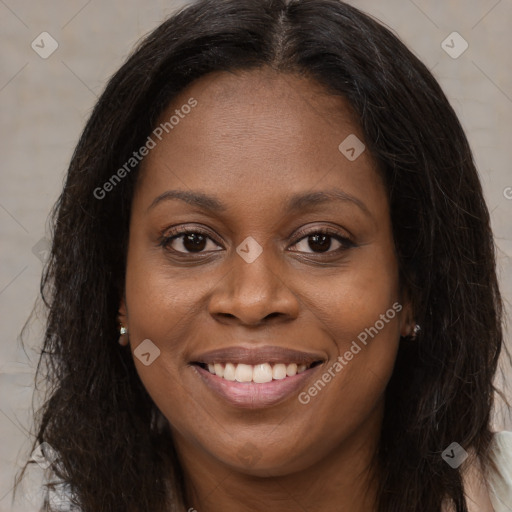 Joyful black young-adult female with long  brown hair and brown eyes