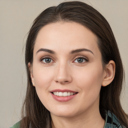 Joyful white young-adult female with medium  brown hair and brown eyes