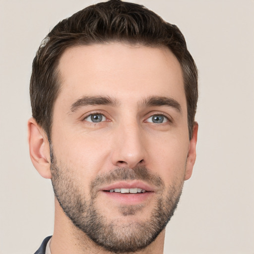 Joyful white young-adult male with short  brown hair and grey eyes