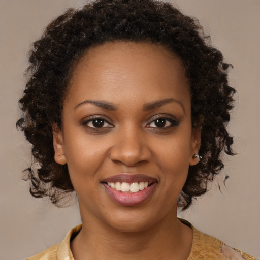Joyful black young-adult female with medium  brown hair and brown eyes