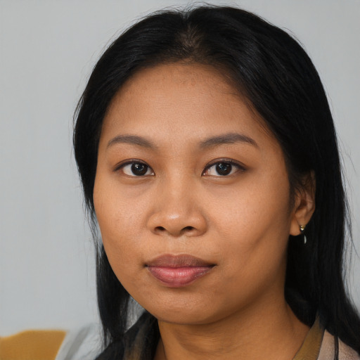 Joyful asian young-adult female with long  black hair and brown eyes